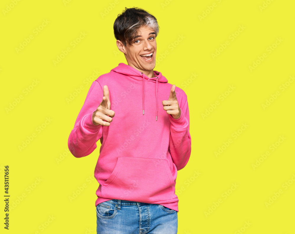 © Krakenimages.com - Young hispanic man wearing casual pink sweatshirt pointing fingers to camera with happy and funny face. good energy and vibes. © Krakenimages.com - Young hispanic man wearing casual pink sweatshirt pointing fingers to camera with happy and funny face. good energy and vibes.