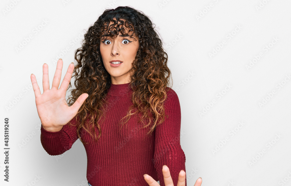 Young hispanic girl wearing casual clothes afraid and terrified with fear expression stop gesture with hands, shouting in shock. panic concept. Young hispanic girl wearing casual clothes afraid and terrified with fear expression stop gesture with hands, shouting in shock. panic concept.