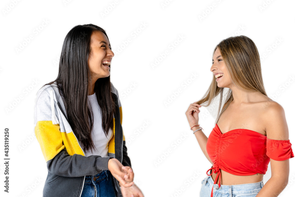 Portrait of Two beautiful women chatting amicably on a white background. Latin women, social communication concept. Portrait of Two beautiful women chatting amicably on a white background. Latin women, social communication concept.