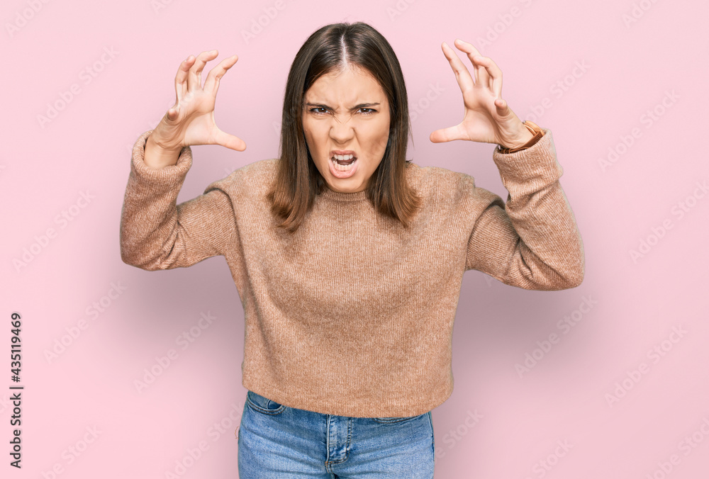 Young beautiful woman wearing casual clothes shouting frustrated with rage, hands trying to strangle, yelling mad Young beautiful woman wearing casual clothes shouting frustrated with rage, hands trying to strangle, yelling mad