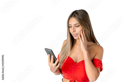 Attractive straight haired woman checking messages on a cell phone or smartphone on a pure white background. studio shot