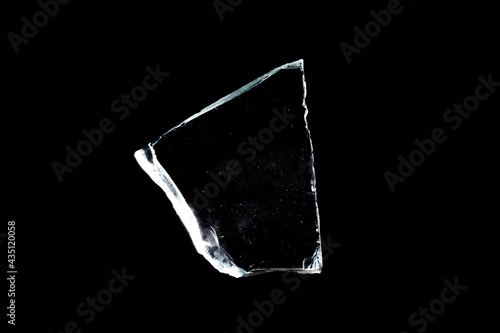 natural glass shard insulated on a black background photo