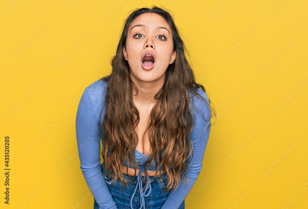 Young hispanic girl wearing casual clothes afraid and shocked with surprise and amazed expression, fear and excited face. Young hispanic girl wearing casual clothes afraid and shocked with surprise and amazed expression, fear and excited face.