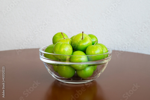 fresh green plum fruits on the table photo