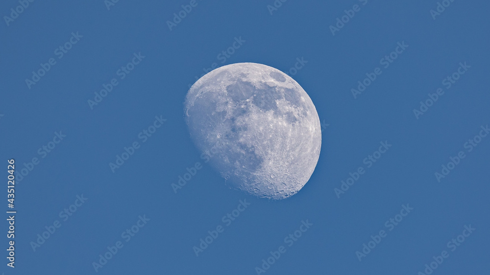 Closeup of waxing gibbous moon during daytime against clear blus sky - Stuttgart, Germany May 22, 2021 Closeup of waxing gibbous moon during daytime against clear blus sky - Stuttgart, Germany May 22, 2021