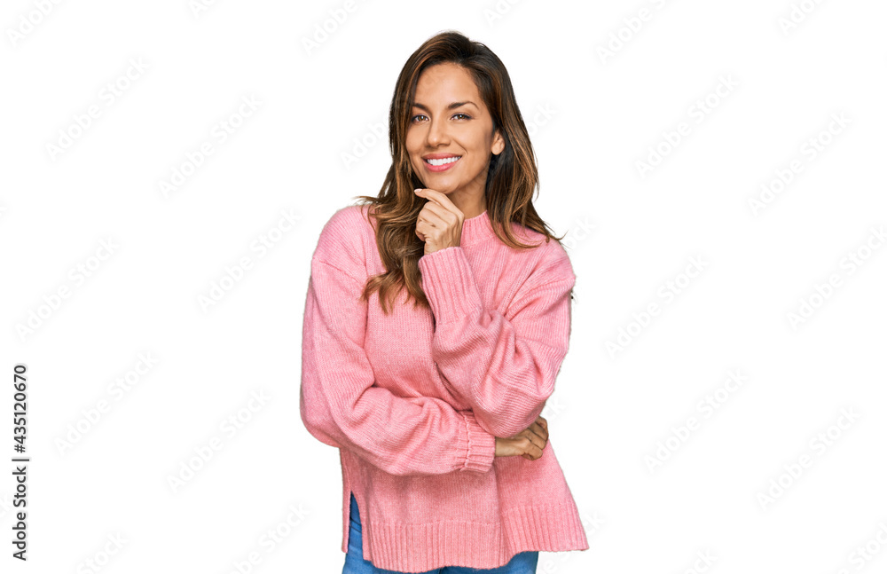 Young hispanic woman wearing casual clothes looking confident at the camera smiling with crossed arms and hand raised on chin. thinking positive. Young hispanic woman wearing casual clothes looking confident at the camera smiling with crossed arms and hand raised on chin. thinking positive.