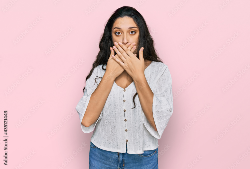 Brunette young woman wearing casual clothes shocked covering mouth with hands for mistake. secret concept. Brunette young woman wearing casual clothes shocked covering mouth with hands for mistake. secret concept.
