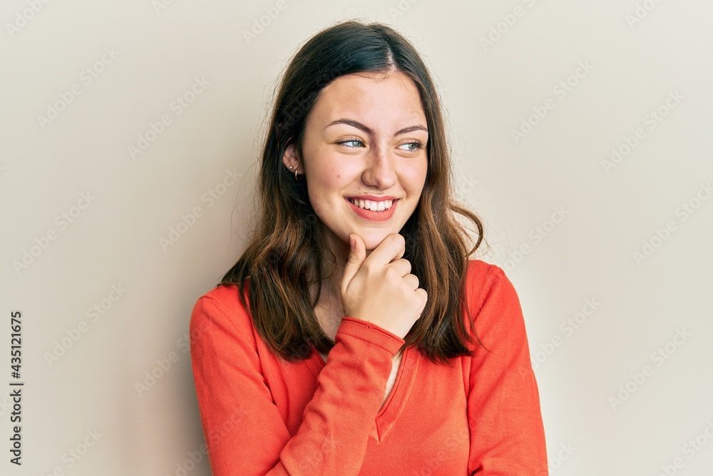 Young brunette woman wearing casual clothes with hand on chin thinking about question, pensive expression. smiling with thoughtful face. doubt concept. Young brunette woman wearing casual clothes with hand on chin thinking about question, pensive expression. smiling with thoughtful face. doubt concept.