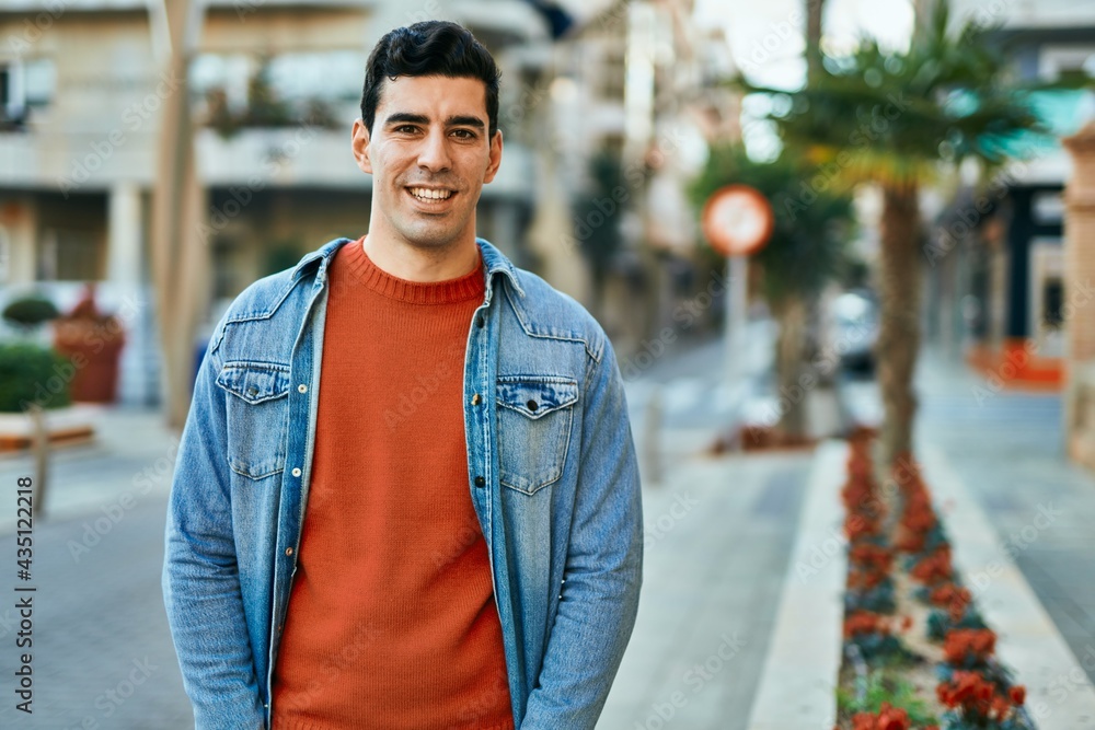 Young hispanic man smiling happy standing at the city. Young hispanic man smiling happy standing at the city.