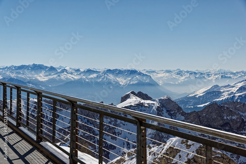 Terrace balcony santis, overlooking imposing mountain landscape, in the daytime with bright sunshine and cloudless sky, swiss mountains are popular destinations with tourists from all over the world photo