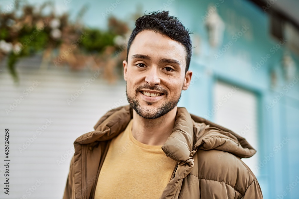 © Krakenimages.com - Young hispanic man smiling happy standing at the city.