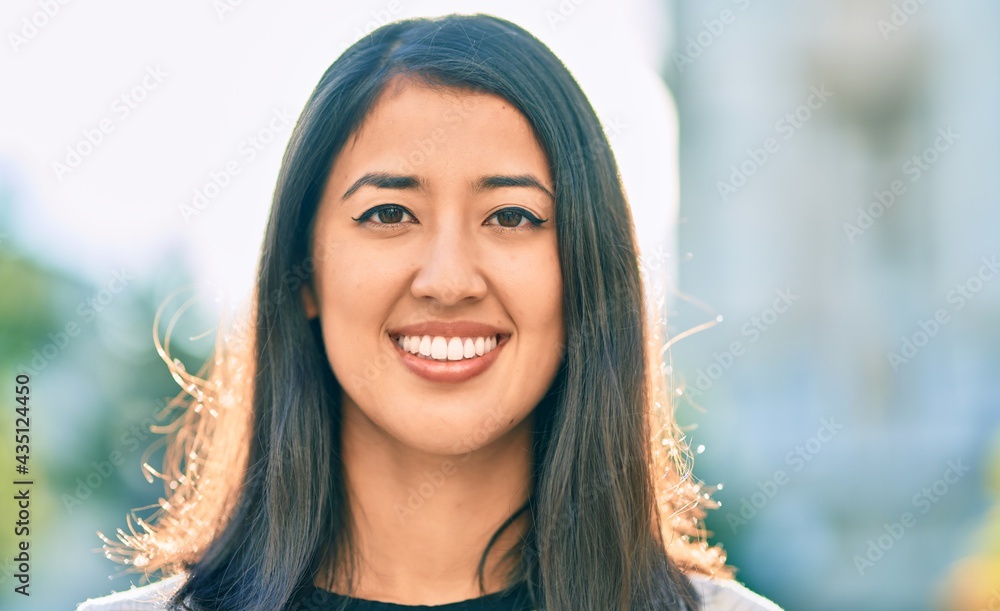 Fototapeta premium Young hispanic woman smiling happy walking at the city.