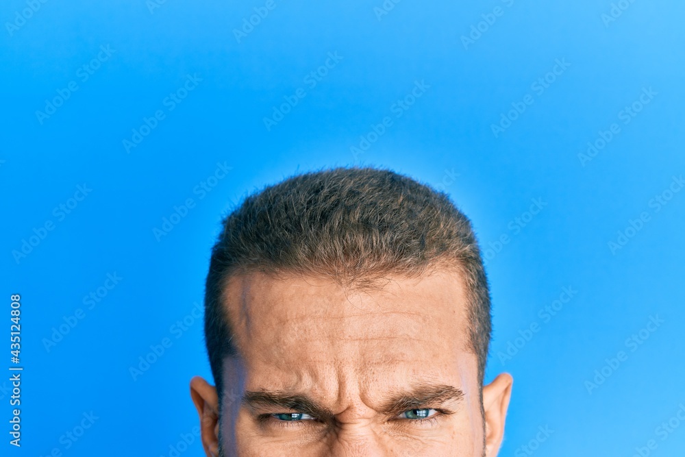 Fototapeta premium Young caucasian man showing head and half face skeptic and nervous, frowning upset because of problem. negative person.