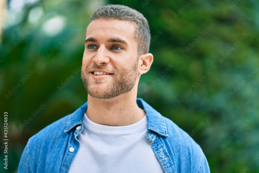 Young caucasian man smiling happy standing at the park. Young caucasian man smiling happy standing at the park.