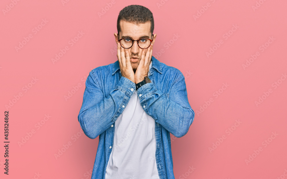 Young caucasian man wearing casual clothes tired hands covering face, depression and sadness, upset and irritated for problem Young caucasian man wearing casual clothes tired hands covering face, depression and sadness, upset and irritated for problem