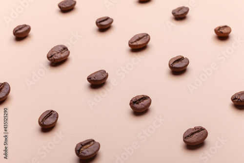 many coffee beans isolated on brown background flat lay pattern, macro photography