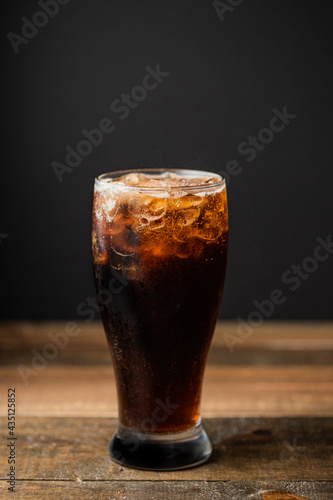 glass of coke on wooden table