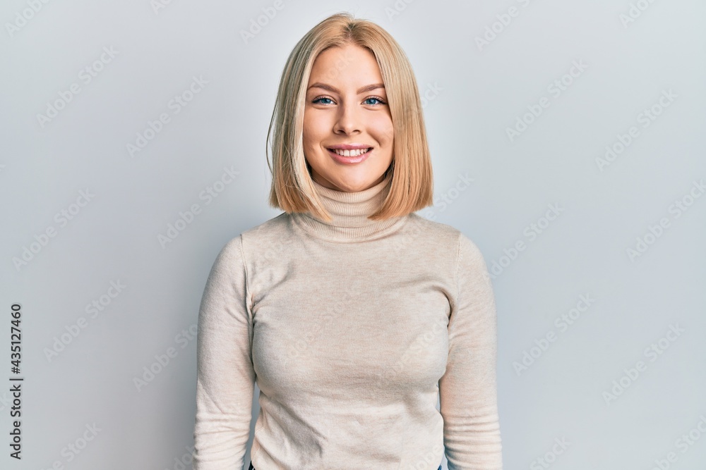 Young blonde woman wearing casual clothes with a happy and cool smile on face. lucky person. Young blonde woman wearing casual clothes with a happy and cool smile on face. lucky person.