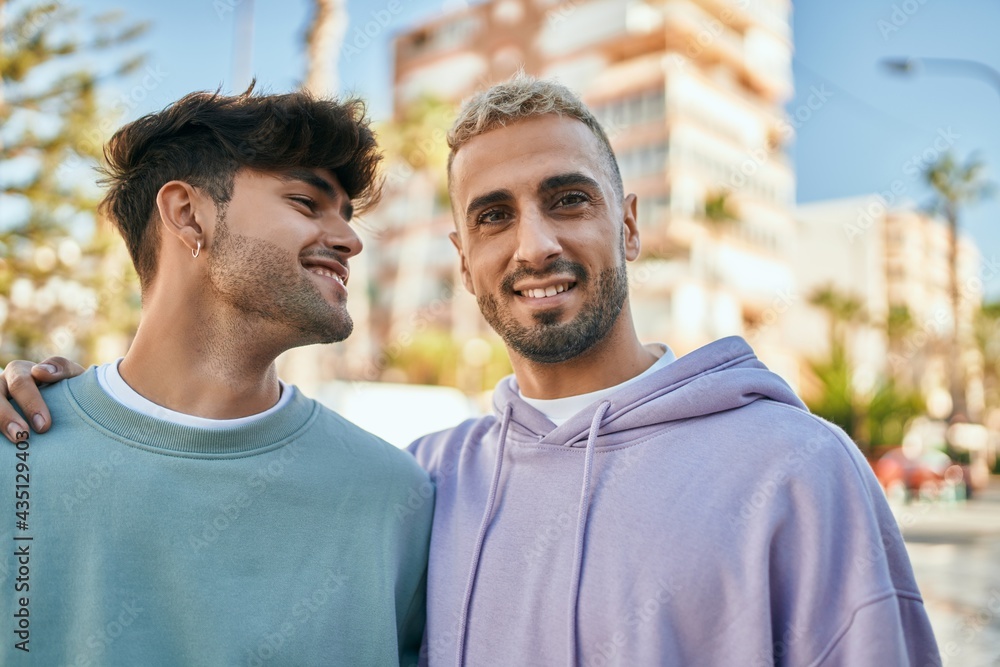 Young gay couple smiling happy and hugging at the city. Young gay couple smiling happy and hugging at the city.