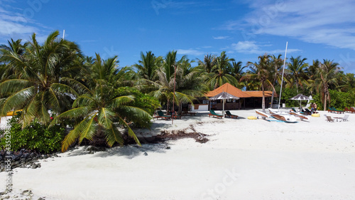 Fototapeta Naklejka Na Ścianę i Meble -  Maldives resort island drone aerial view, Indian ocean atoll nature beach and palm forest, leisure tourist luxury vacation