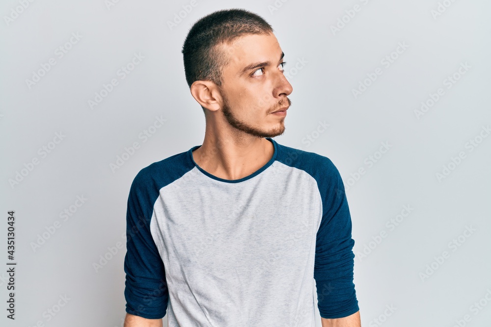 Fototapeta premium Hispanic young man wearing casual clothes smiling looking to the side and staring away thinking.