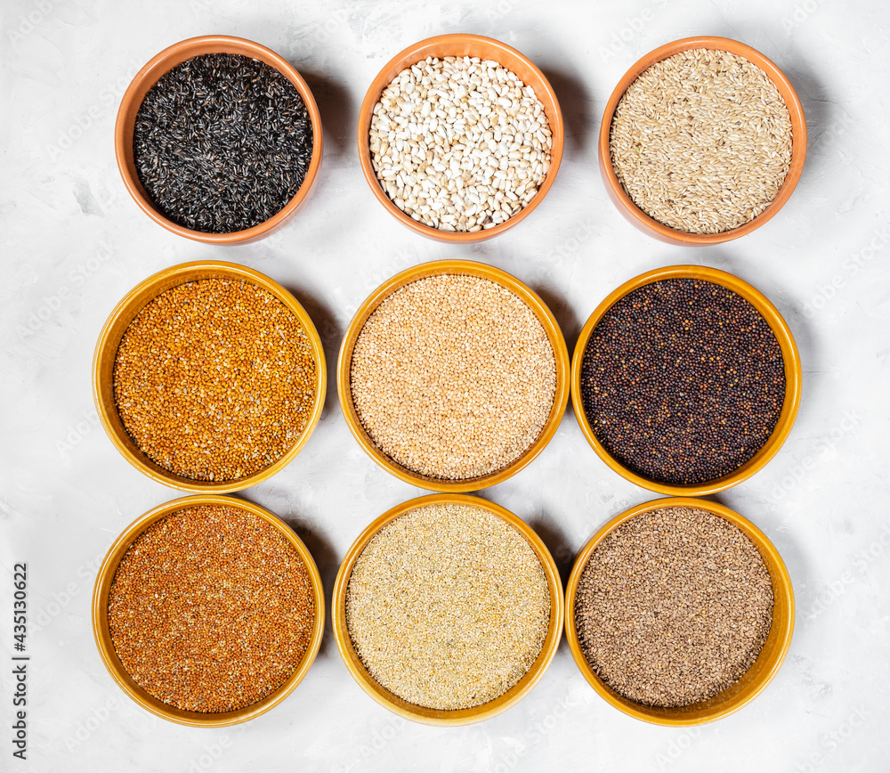 top view of various bird seeds in ceramic bowls top view of various bird seeds in ceramic bowls
