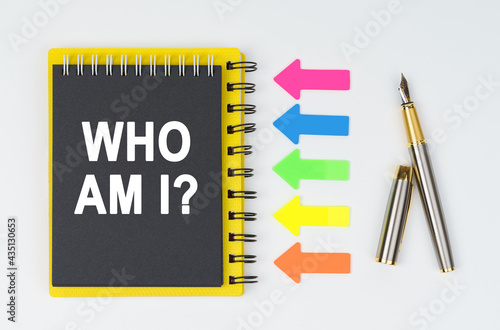 Wallpaper Mural On a white background lies a pen, arrows and a notebook with the inscription - WHO AM I Torontodigital.ca