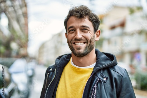 Handsome hispanic man with beard smiling happy outdoors © Krakenimages.com