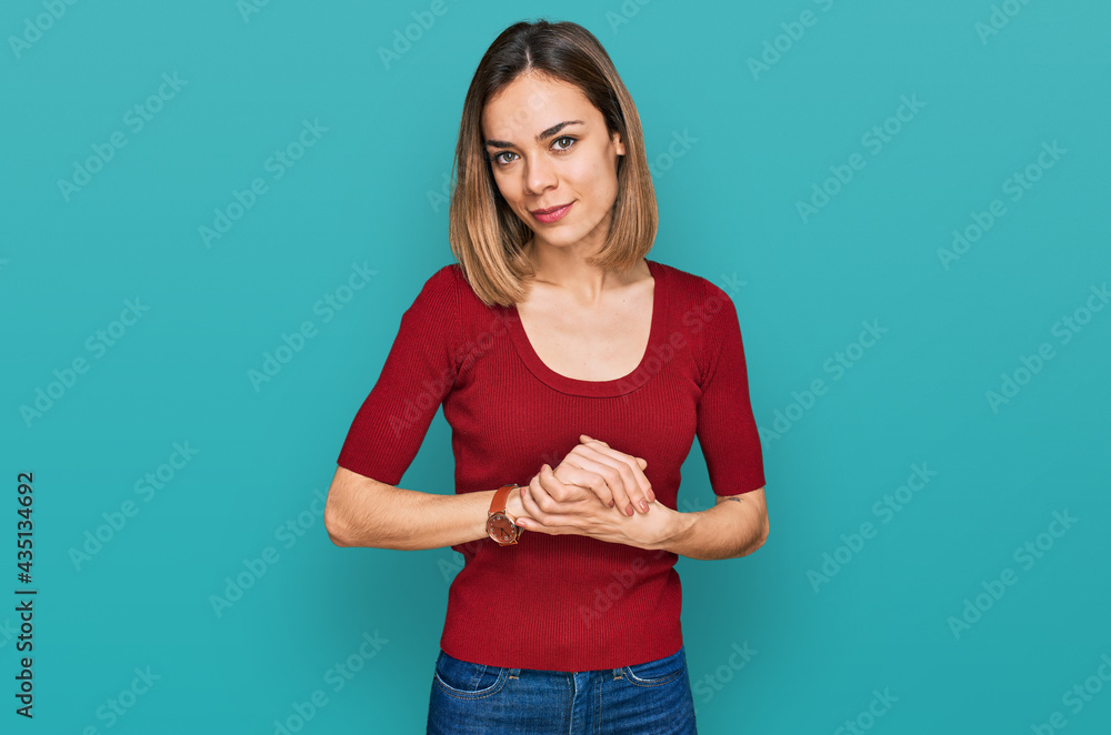Young blonde girl wearing casual clothes with hands together and crossed fingers smiling relaxed and cheerful. success and optimistic Young blonde girl wearing casual clothes with hands together and crossed fingers smiling relaxed and cheerful. success and optimistic