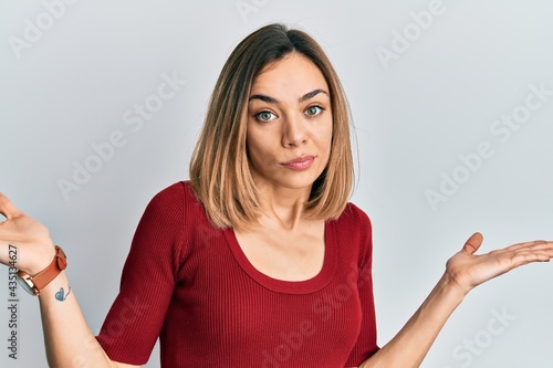 Wallpaper Mural Young caucasian blonde woman wearing casual jumper clueless and confused with open arms, no idea and doubtful face. Torontodigital.ca