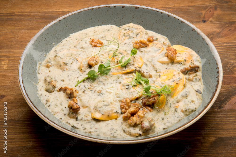 Baked potato with a mushroom cream sauce, mozzarella and fresh basil leaves. Baked potato with a mushroom cream sauce, mozzarella and fresh basil leaves.