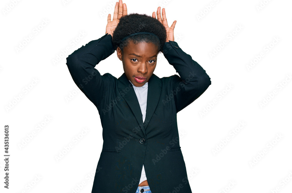 Young african american girl wearing business clothes doing bunny ears gesture with hands palms looking cynical and skeptical. easter rabbit concept. Young african american girl wearing business clothes doing bunny ears gesture with hands palms looking cynical and skeptical. easter rabbit concept.
