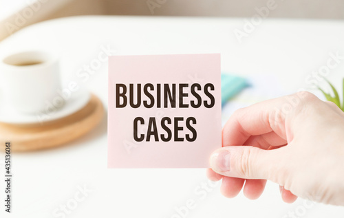 On the table is a notebook, a pen and a business card with the inscription - BUSINESS CASES