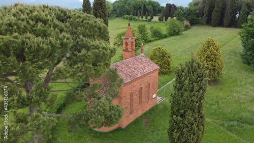 Drone view footage from above of the red church of Pomelasca located in the Lombardy countryside, Inverigo, province of Como, Brianza, Italy, Europe photo