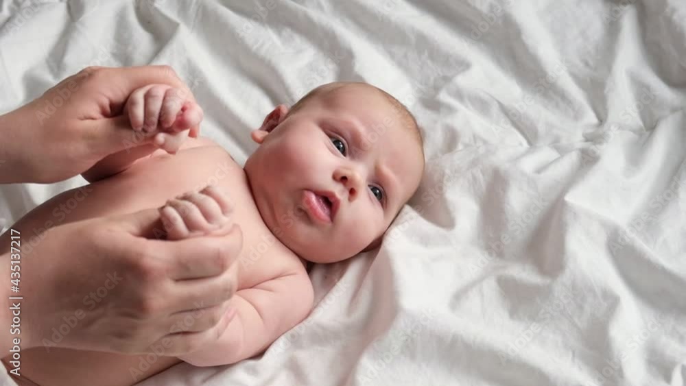 Mother Playing with Baby Hands. Stretching and Exercises for Child Development. Mother Holding Hands her Newborn Baby. Concept of Parenthood, Childhood, Maternity, Motherhood. Neonate Toddler and Mom Mother Playing with Baby Hands. Stretching and Exercises for Child Development. Mother Holding Hands her Newborn Baby. Concept of Parenthood, Childhood, Maternity, Motherhood. Neonate Toddler and Mom