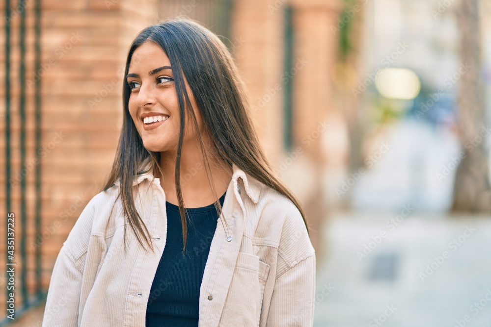 Young hispanic girl smiling happy standing at the city. Young hispanic girl smiling happy standing at the city.