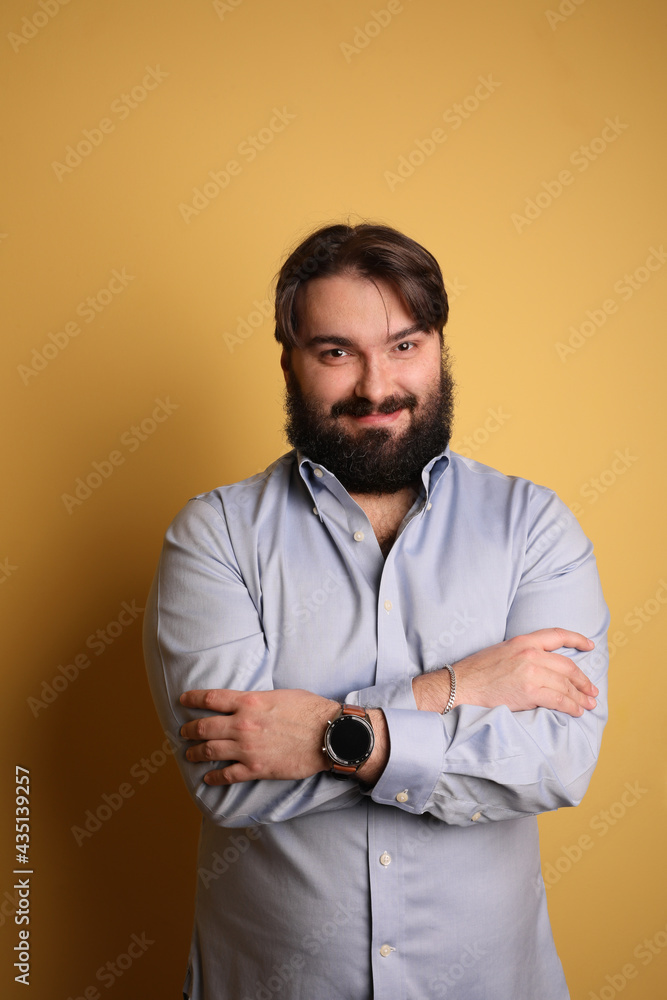 Happy big man with beard, posing over yellow background. Vertical. Happy big man with beard, posing over yellow background. Vertical.
