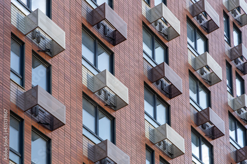 The facade of a new high-rise building with windows and compartments for external blocks of split systems. Fastening outdoor units of air conditioners photo