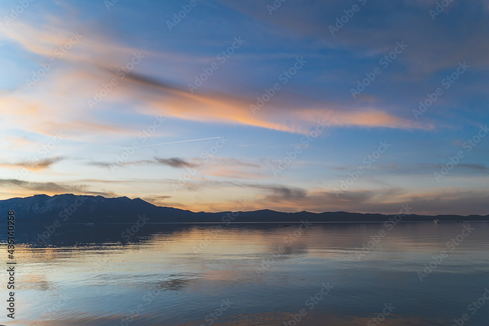 Colorful clouds reflecting in water over Lake Tahoe California after sunset