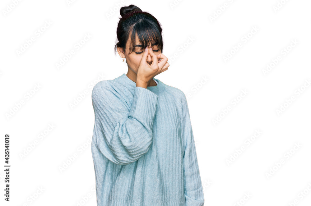 Young hispanic woman wearing casual clothes tired rubbing nose and eyes feeling fatigue and headache. stress and frustration concept. Young hispanic woman wearing casual clothes tired rubbing nose and eyes feeling fatigue and headache. stress and frustration concept.