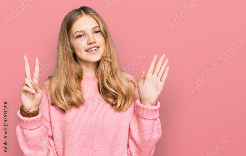 Beautiful young caucasian girl wearing casual winter sweater showing and pointing up with fingers number seven while smiling confident and happy.