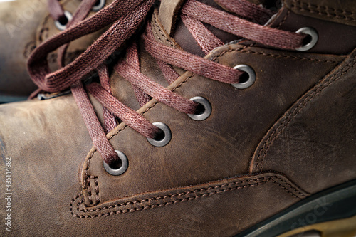 close up. part of winter brown leather men's shoes. shoelaces