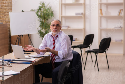 Old businessman employee sitting in the office