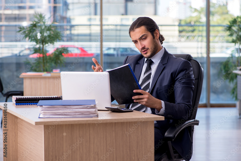 Young businessman employee working in the office Young businessman employee working in the office