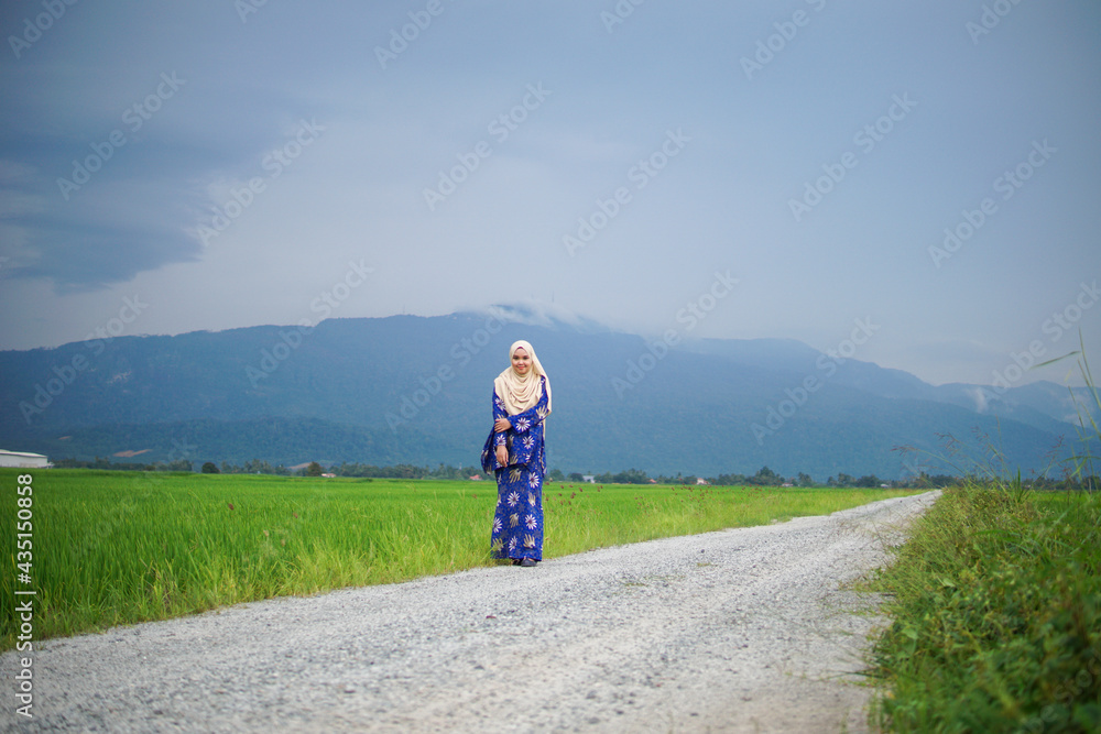 Portrait of Muslim Asian woman posing at paddy field Gunung Jerai, Kedah.