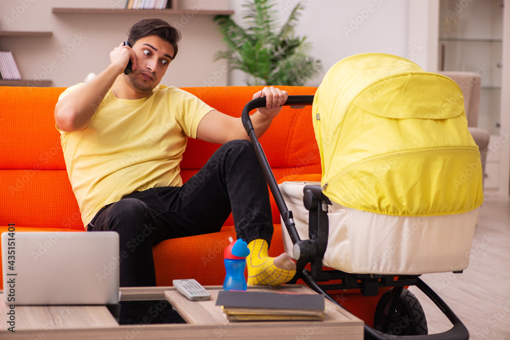 Young man looking after new born at home Young man looking after new born at home
