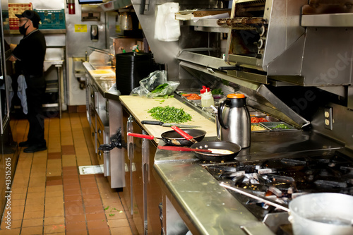 Obraz na płótnie A view inside the food and order assembly area inside a restaurant kitchen