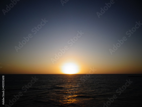 [Madagascar] The beach dyed orange and the sun setting on the horizon in Salary bay © marimos