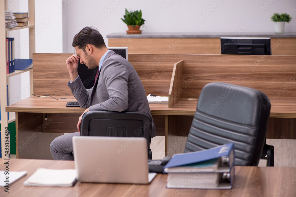 Young businessman employee working in the office Young businessman employee working in the office