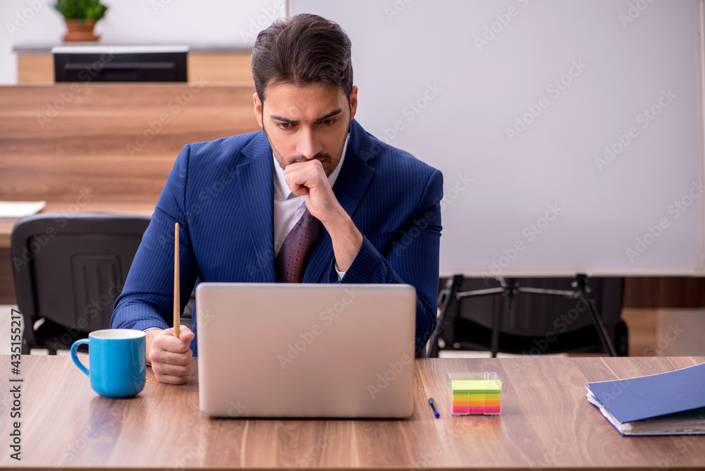 Young handsome employer in teleconference concept Young handsome employer in teleconference concept